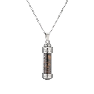 Detailed macro view of the openable perfume bottle pendant filled with tiger eye stones