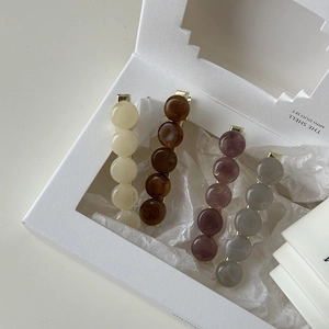 Detailed set of four colorful resin hair clips presented in an elegant white gift box