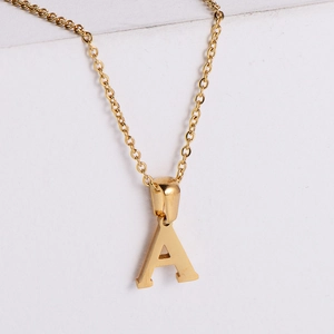 Macro shot of 18k gold plated letter A pendant on a minimalist stainless steel chain