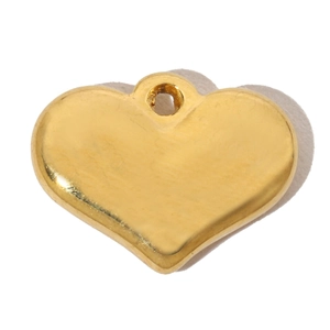 Detailed view of a gold heart pendant with crystal accents and smooth metal finish