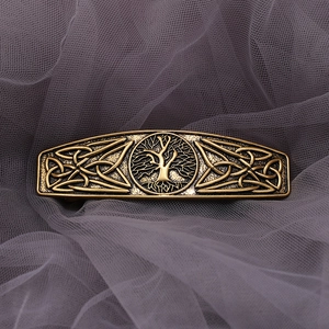 Macro view of vintage tree of life metal hair clip with Celtic knot details