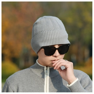 Close-up of grey knit beanie texture featuring detailed ribbing and thick winter fabric