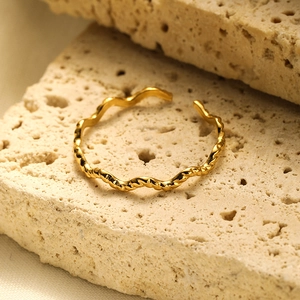 Detailed close-up of a minimalist 18K gold plated stainless steel open ring band