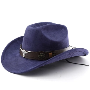 Detail of western cowboy hat with silver bull head emblem and brown leather strap