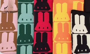 Close-up of colorful cartoon rabbit patterns on knitted tote bags in various colorways