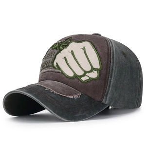 Detail of vintage washed canvas baseball cap with patchwork design and fist embroidery