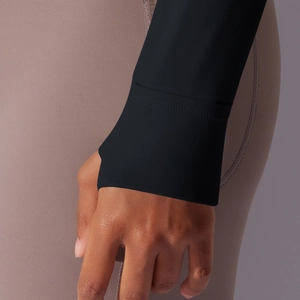 Detail of flatlock reinforced cuffs on a black hooded athletic jacket for women