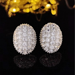 Elegant oval hollow silver stud earrings with sparkling white cubic zirconia on black mirror