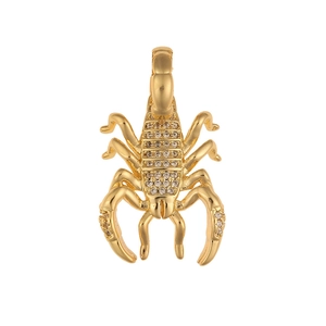 Detailed close-up of a gold scorpion pendant featuring sparkling clear crystals and polished metal