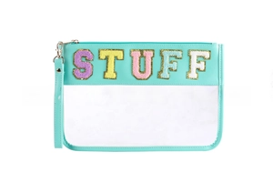 Macro view of mint green PVC toiletry bag with STUFF chenille patches and gold trim