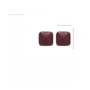 Detail of square faux leather earrings with textured crocodile pattern and silver pins