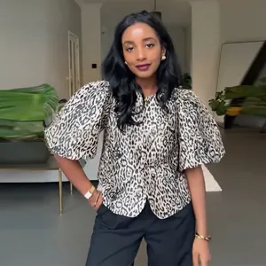 Women's trendy leopard print top featuring stylish puff sleeves and button-up front