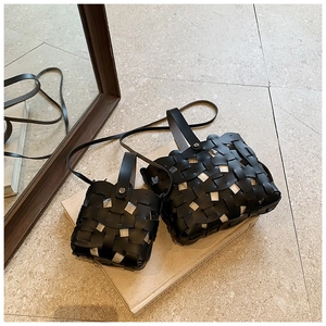 Detailed comparison of large and small black woven PU leather crossbody bags in lifestyle setting
