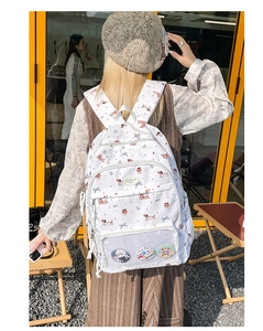 Detail view of white dachshund pattern backpack with colorful polka dots and mesh pocket