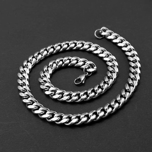 Macro shot of a silver Cuban link chain necklace with a secure lobster clasp