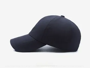Side view detail of a dark blue breathable baseball cap with micro-letter embroidery