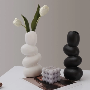 Modern minimalist pebble ceramic vases in matte black and white for home decor