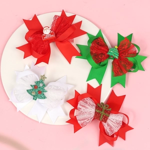 Set of 4 Christmas bow hair clips with Santa and tree charms on a white plate