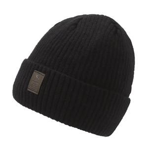 Black ribbed knit beanie with fleece lining and brown leather patch on white background
