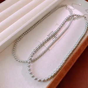 Elegant silver-gray pearl necklace with metallic luster and silver lobster clasp
