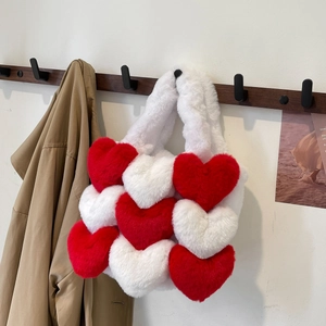 Chic red and white plush heart-shaped tote bag hanging with a classic trench coat
