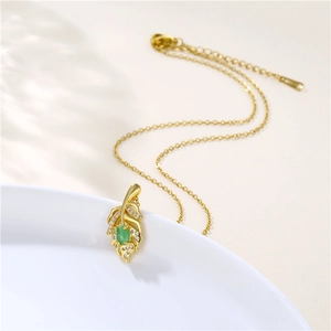 Golden leaf pendant necklace with green oval gemstone and micro-pave cubic zirconia