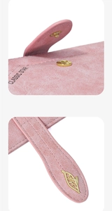 Detail of pink leather passport holder with golden leaf snap button and classic star logo