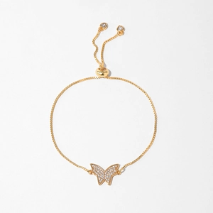 Detail of adjustable gold-plated bracelet with pavé butterfly and heart charms
