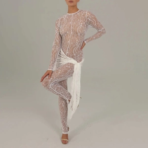 Close-up of intricate white lace embroidery and sheer fabric detail on long sleeve jumpsuit