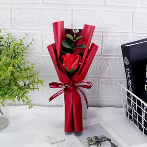 Close-up of red soap flower sunflower wrapped in gift paper with 'Just For You' ribbon