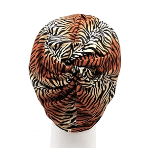 Tiger print jersey turban headband with twist knot detail on white mannequin head