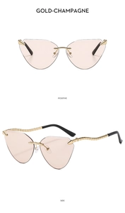 Detail of rimless cat-eye sunglasses with champagne lenses and slim gold metal temples