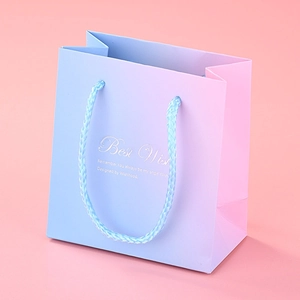 Pink and blue gradient gift paper bag with woven handles and Best Wish printed text