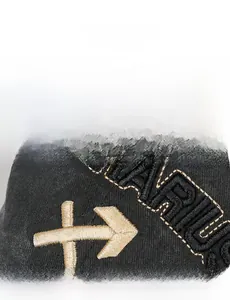 Macro shot of detailed gold and black embroidery on a vintage washed cotton baseball cap