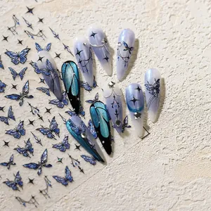 Macro detail of blue gradient butterfly nail stickers with star patterns on long nails