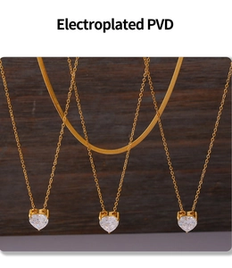 Detail of 18k gold plated heart zircon pendant showing PVD coating and layered necklace