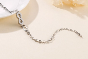 Macro shot of polished silver infinity link chain bracelet with adjustable clasp