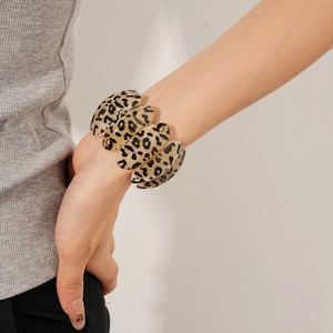 Detail of leopard print oval resin panels linked on a vintage stretch bracelet