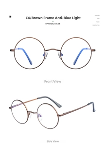 Detail van ronde bruine metalen bril met beschermende glazen tegen blauw licht