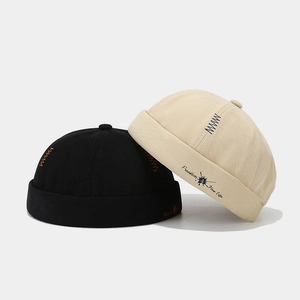 Minimalist cotton brimless docker caps in black and beige with Freedom embroidery