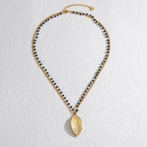 Elegant 18k gold starfish leaf pendant necklace with black beads on a polished chain