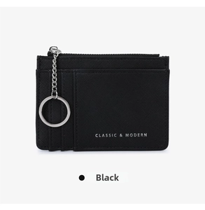 Macro view of black Saffiano leather coin purse with card slots and silver keychain