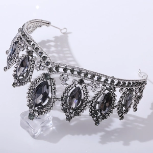 Detail of silver bridal crown featuring black oval crystals and rhinestone embellishments