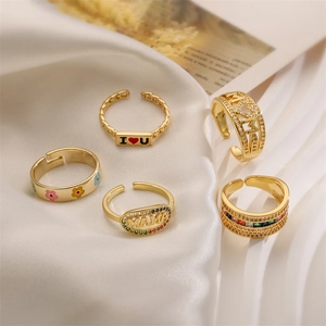 Detailed set of five gold-plated rings featuring MAMA lettering and colorful zircons