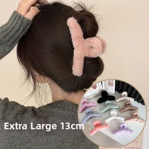 Detail view of 13cm oversized plush hair claw clip showing soft texture and large size