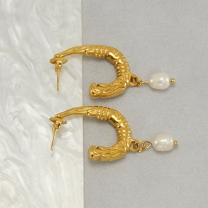 Elegant U-shaped gold stainless steel earrings with textured finish and white pearls