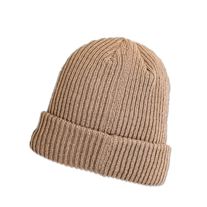 Close-up of khaki knit beanie showing premium ribbed texture and folded cuff details