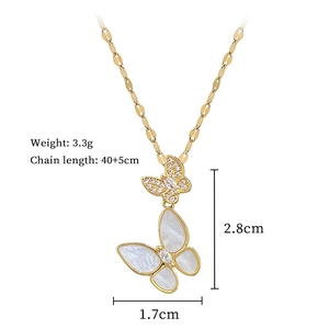 Detailed view of titanium butterfly necklace with white shell and zircon pave in gold