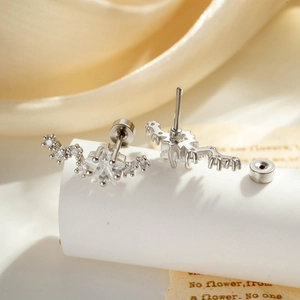 Silver star and wave ear studs with sparkling rhinestones and screw back closure