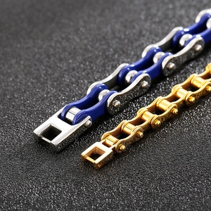 Detail of bike chain style stainless steel bracelet in blue-silver and gold finish